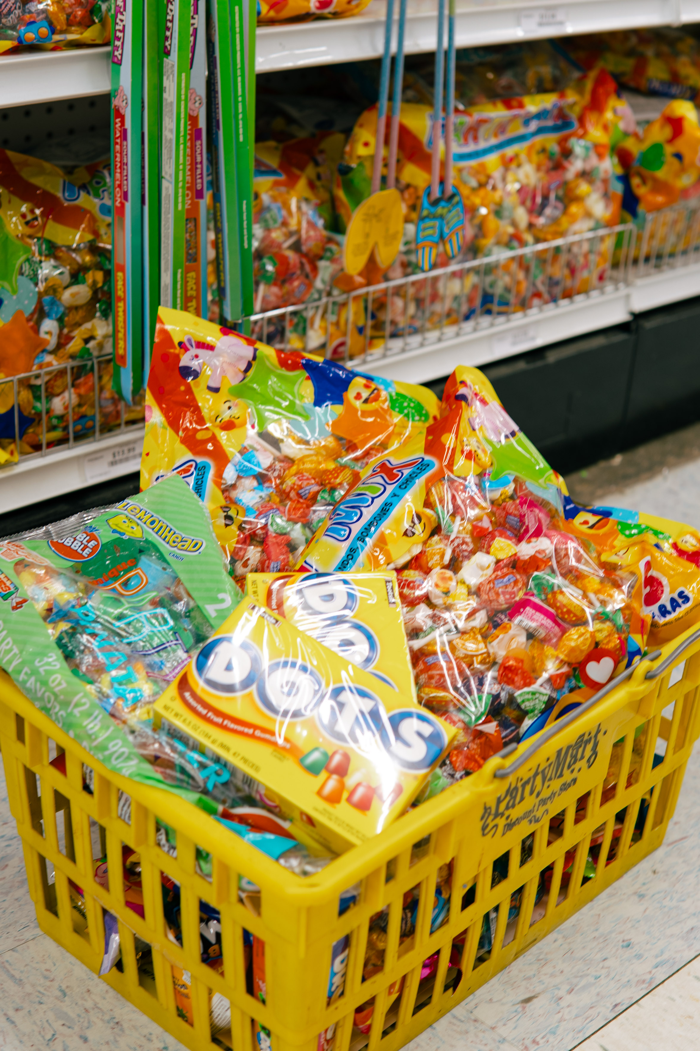 Yellow basket filled with assorted party candy and piñata treats